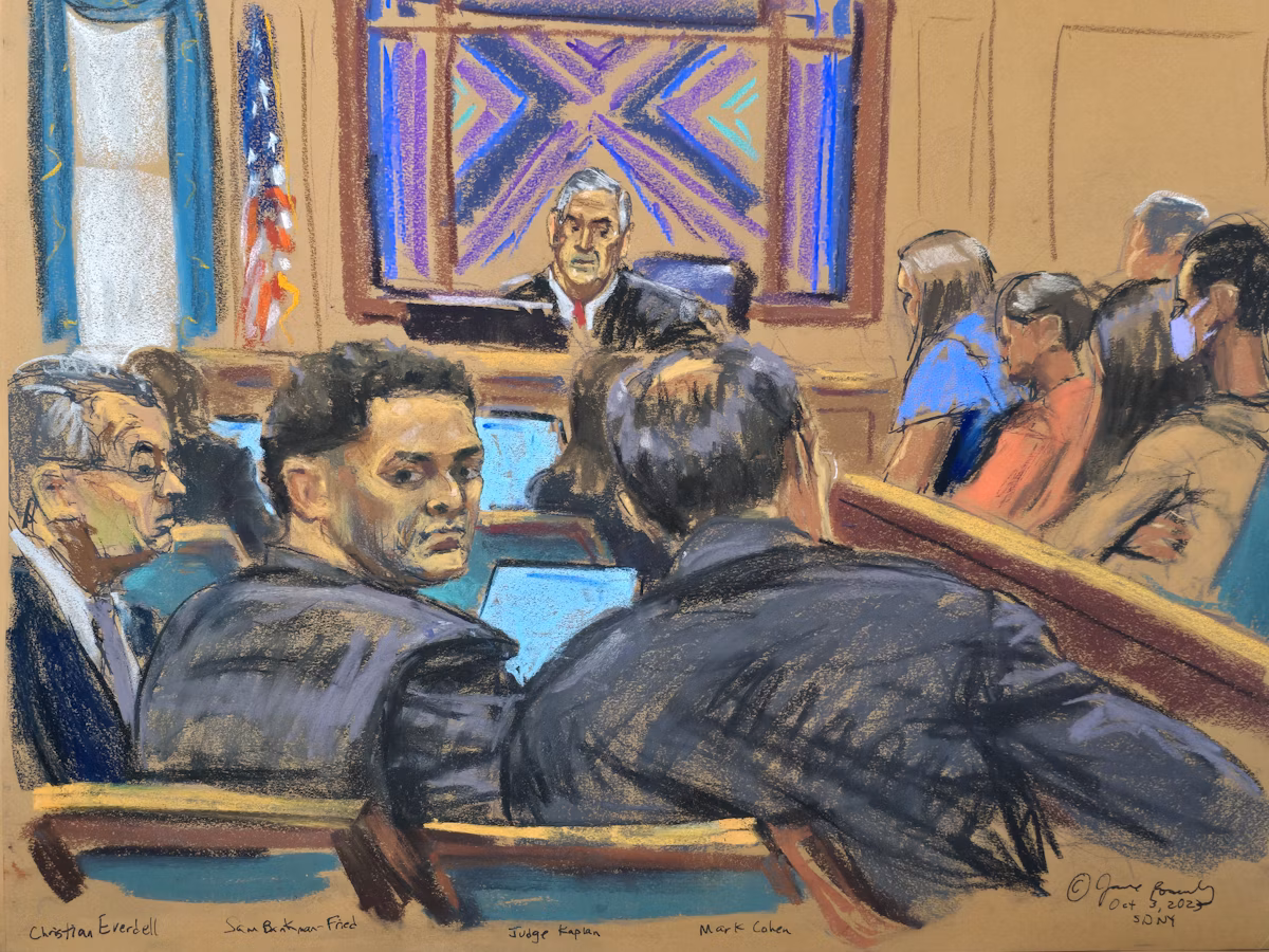 Sam Bankman-Fried looking back from defense table